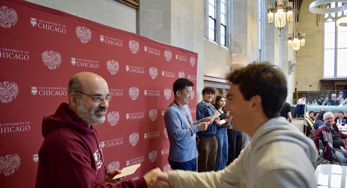 Professor Victor Lima shakes hands with prize winner while Professor Kotaro Yoshida emcees the annual Undergraduate BBQ